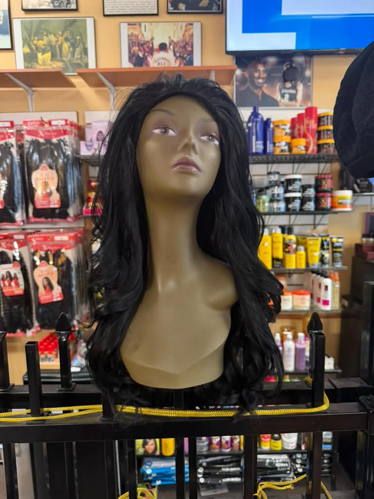 Long black wavy lace front wig on a display mannequin at Beyond Image Suites and Supplies in Cincinnati, front view