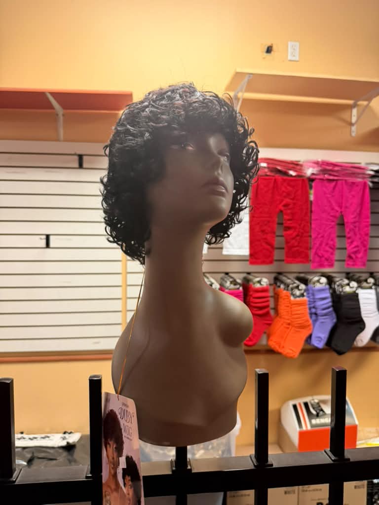 Outre Duby 100% human hair short curly black wig with bangs on a mannequin at Beyond Image Suites and Supplies