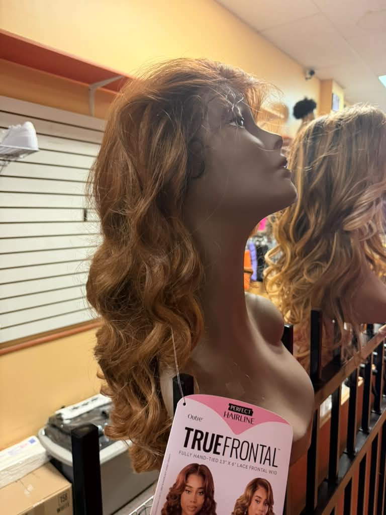Side view of an Outre Perfect Hairline True Frontal auburn copper wavy lace frontal wig at Beyond Image Suites and Supplies
