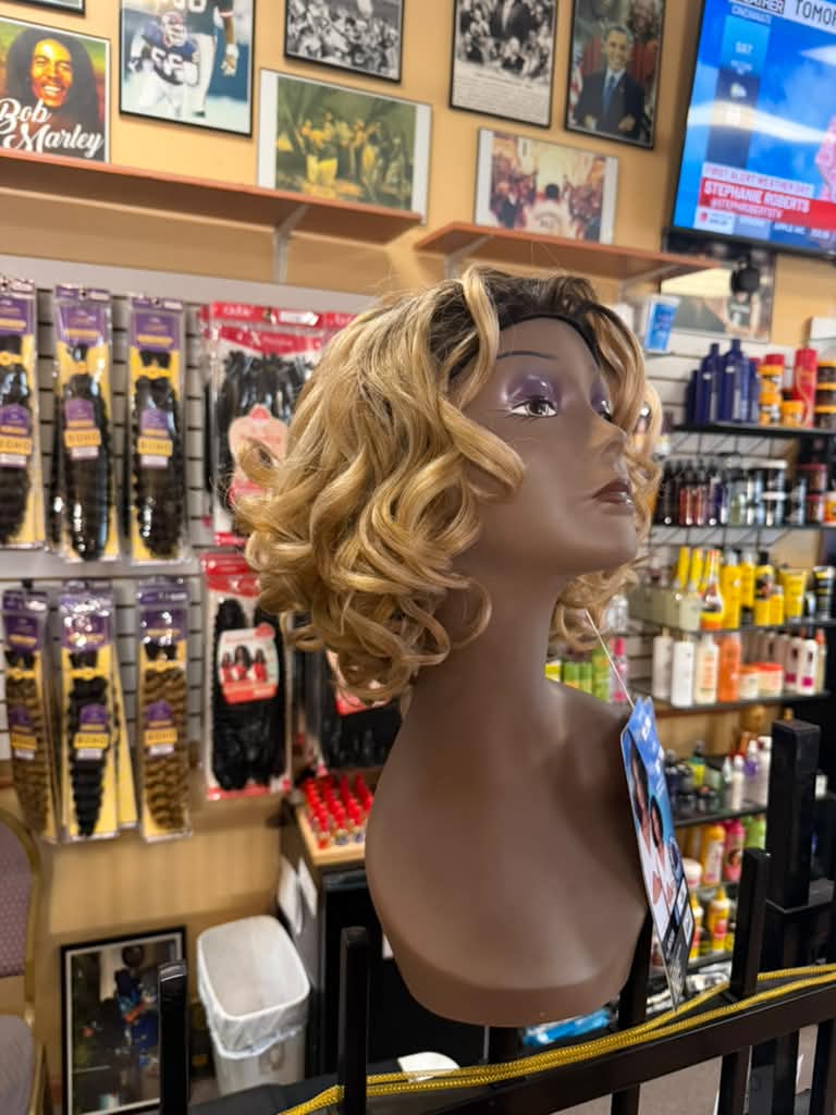 Side view of the Outre Rossa blonde ombre curly bob wig with dark roots at Beyond Image Suites and Supplies