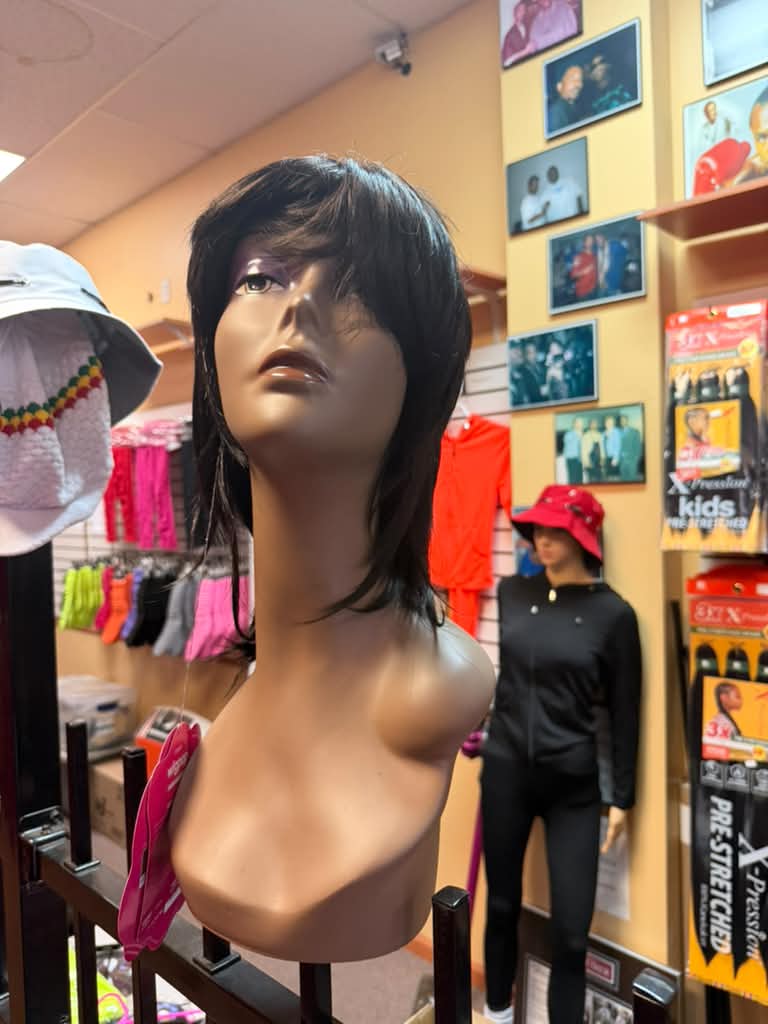 Front angle of the Outre Wigpop Jovi dark brown layered shag wig with bangs in the Cincinnati wig department