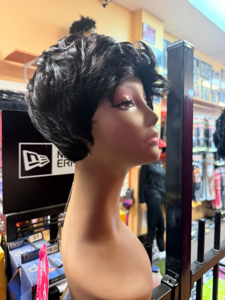 Side view of a short black curly pixie cut wig on a mannequin at Beyond Image Suites and Supplies in Cincinnati