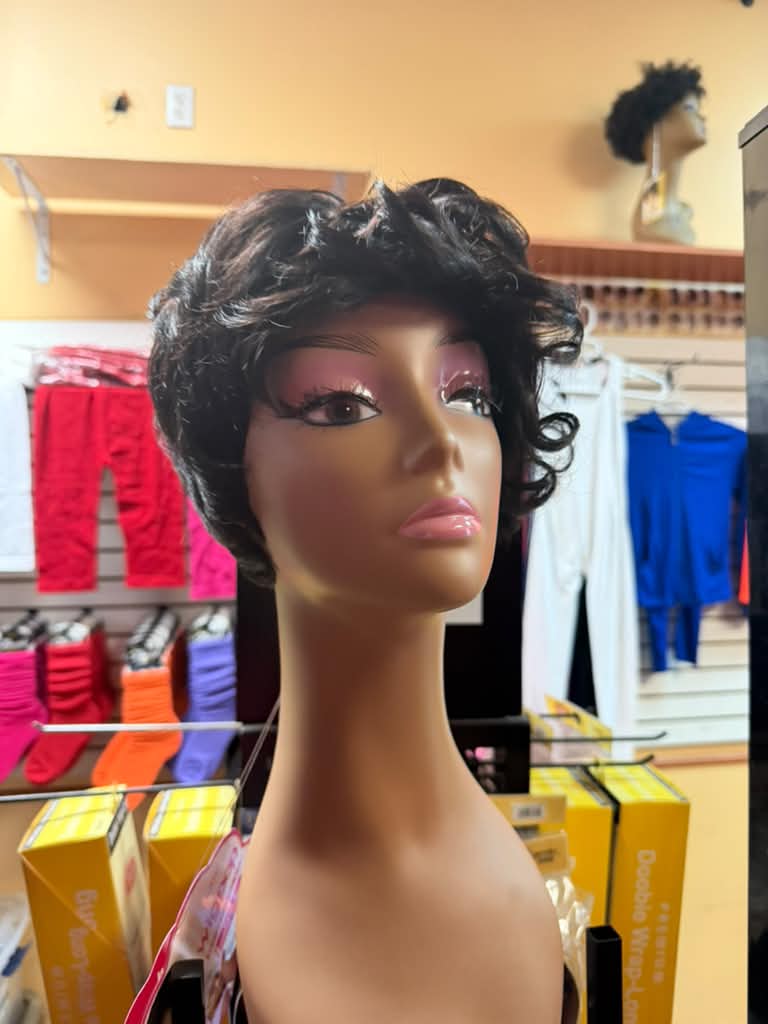 Front view of a short dark brown curly pixie wig on a mannequin at Beyond Image Suites and Supplies in Cincinnati